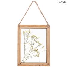dried yellow flowers framed wood wall