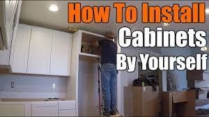 First, locate the highest point in your floor using your level. How To Install Upper Kitchen Cabinets By Yourself The Handyman Youtube