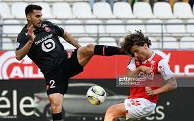 Lille's Turkish defender Zeki Celik fights for the ball with Reims'... News  Photo - Getty Images