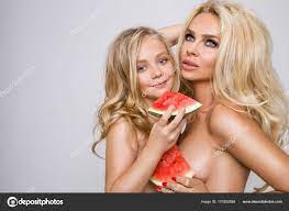 Beautiful blonde female model, mother with blonde daughter hug. They have  beautiful tanned body. Stock Photo by ©marcink3333 170252884