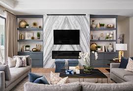 Tropical living room features gray sectionals and a glass top coffee table facing the fireplace enclosed in glass. Fossil Creek Living Room Fireplace Wall Transitional Family Room Austin By Haven Design And Construction Houzz