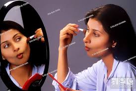south asian indian applying makeup