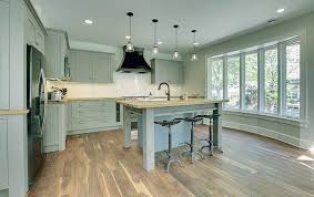 The detailing on these dark cabinets gives them a traditional look. Green Kitchen Cabinets Design Ideas Designing Idea