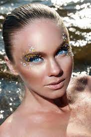 woman with sparking makeup at beach