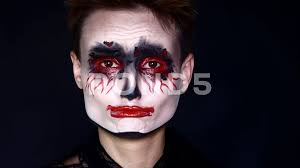 sad joker woman in halloween makeup