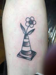 Got a nice lil flower traffic cone on my arm today by Ethan Bennett ( ig:  ethanbennett_tattoos ) | Hand tattoos, Tattoos, Leg tattoos