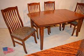 An amish made oak dining table with eight matching chairs (two with arms and six without arms). Amish Oak Dining Table Jasen S Fine Furniture Since 1951