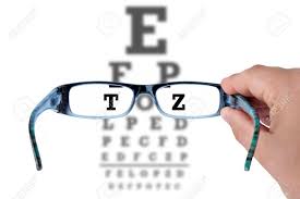 Hand Holding Glasses And Reading Eye Chart Test Vision On White