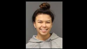 nc woman smiles in mugshot after being