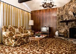 (spring 1963) the room features a walnut paneled wall, custom tufted curved sofa, coffee table of picked cork and a large travertine fireplace. The Best Decorating Trends From The 70s 70s Decorating Ideas