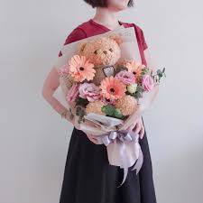 bear with fresh flower bouquet