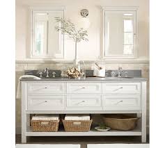 Sophisticated bathroom features a black vanity topped with white quartz placed under a nailhead mirror, pottery barn farrah nailhead mirror, illuminated. Classic 72 Double Sink Vanity Pottery Barn