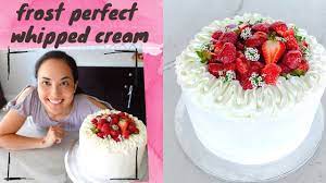 decorating a cake with whipped cream