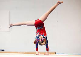 young gymnast performs cartwheel