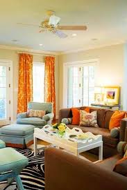 orange curtains and brown couch