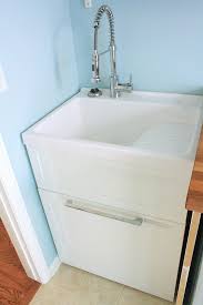 We considered buying a single kitchen base cabinet, but it doesn't seem worth the hassle of separately sourcing a cabinet, counter, and sink for this fairly lightly used location. Ove Utility Sink Cabinet Http Www Costco Com Daisy White Vanity Style Utility Sink With Faucet By New Wa Laundry Room Sink Laundry Sink Laundry Room Makeover