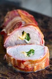 Pork tenderloin seasoned with a rub, seared until golden then oven baked in an incredible honey garlic sauce until it's sticky on the outside and juicy on the inside! Traeger Smoked Stuffed Pork Tenderloin Easy Bacon Wrapped Tenderloin