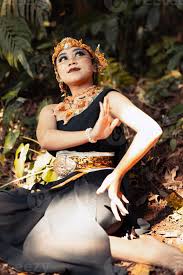 indian woman sitting with a black dress