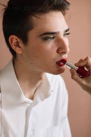 non binary man having makeup applied