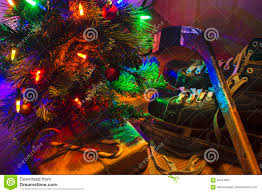 Low Key Image Of A Lit Christmas Tree With Skates And Hockey