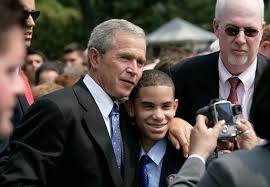 Bush was a us deep politician who headed the us deep state for over 20 years. President George W Bush Poses For A Photo With A Young Man Wearing A Button In