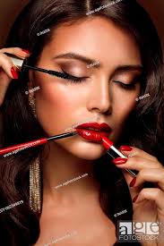 beauty model put on red lipstick