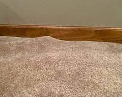 what causes carpet to buckle or ripple