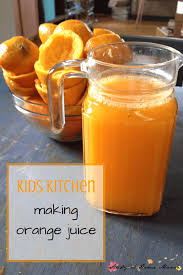 kids kitchen making orange juice