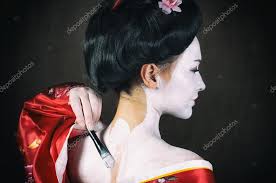 applying geisha makeup stock photo