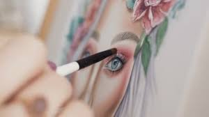 Make Up Artist Comes Up With Makeup Using A Face Chart The Artist Makeup Paints Face Woman On Paper And Smears A Small Brush Using Palette Of Eyeshadows For Eyes