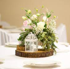 Renting a centerpiece will cost less than buying and will ultimately save you time, resources and reduce the frazzlement factor. These Wood Slab Centerpieces Will Steal The Show At Any Rustic Wedding Reception Wood Centerpieces Rustic Wedding Decor Wood Slab Centerpiece