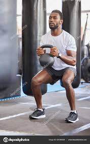 black man gym kettlebell squat exercise