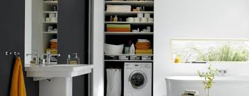Stacked washer and dryer hidden behind a black barn door on rails in a cottage basement boasting green cabinets and light oak wood floors. 6 Brilliant Ideas To Hide The Washing Machine In The Bathroom Homify