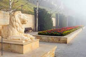Sculpture Of Lion In Foggy Morning On