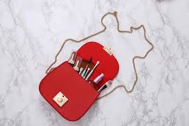 red leather bag with makeup accessories