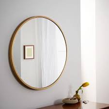 metal framed round brass wall mirror