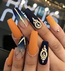 The accent nail is decorated with rhinestones and a pretty stripe. Long Matte Orange Nails Matte