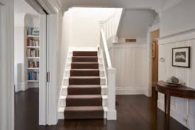 white staircase with carpet runner