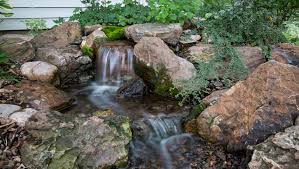 The husband put in a pondless waterfall as part of our big backyard makeover! Diy Waterfall Building A Backyard Waterfall Tips And Tricks