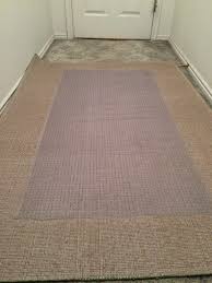 how to secure an area rug over carpet