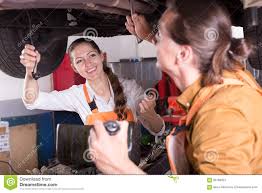 Mechanic And Assistant Working At Workshop Stock Image