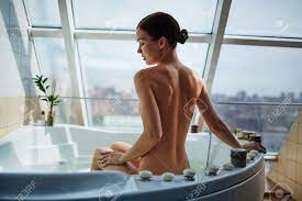 Naked Woman Sitting In Bathtub In Her Modern Bathroom Stock Photo, Picture  and Royalty Free Image. Image 47784756.