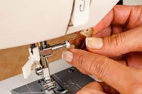 repairing a jammed sewing machine