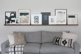 diy picture ledge over the couch filled