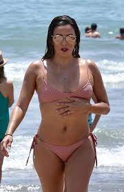 Eva Longoria shows off her pert bum and slender frame as she hits the beach  in a pink bikini on holiday 