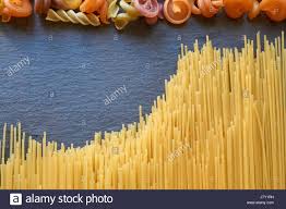 Thin Spaghetti And Other Pasta On A Black Slate Stone Look