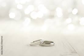two wedding rings place on wooden floor
