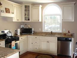 The wood used in the cabinets throughout the kitchen was distressed to match the reclaimed stone and marble. Kitchen Kitchen Wall Paint Colors With Cream Cabinets