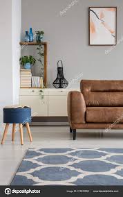 navy blue stool next leather sofa grey