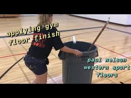 applying gym floor finish with the